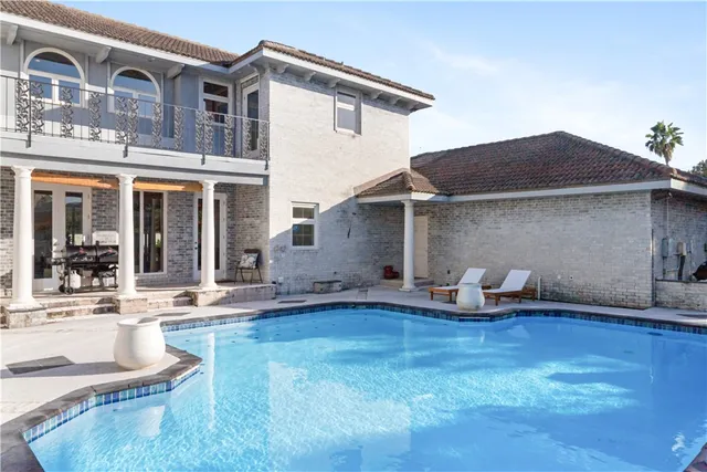 an aerial view of a house with pool table and chairs