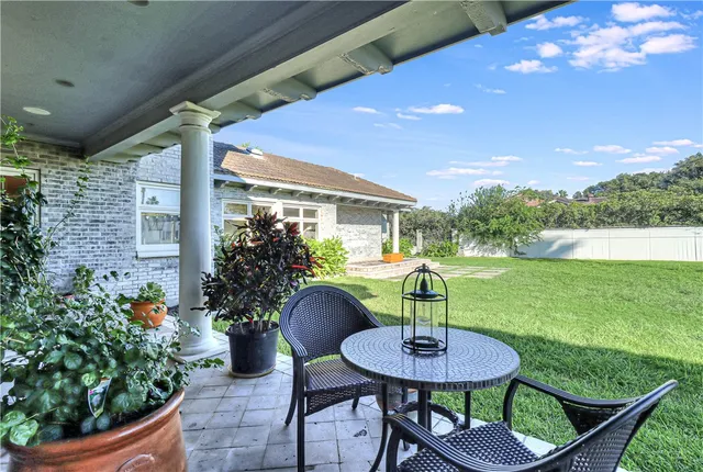 a front view of a house with a garden and patio