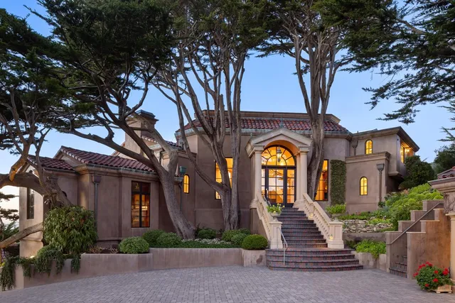 a front view of a house with a garden