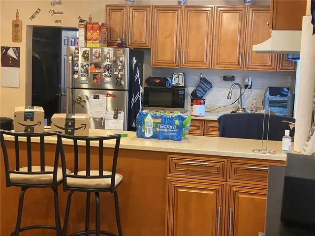 a kitchen with stainless steel appliances granite countertop a refrigerator and a stove top oven