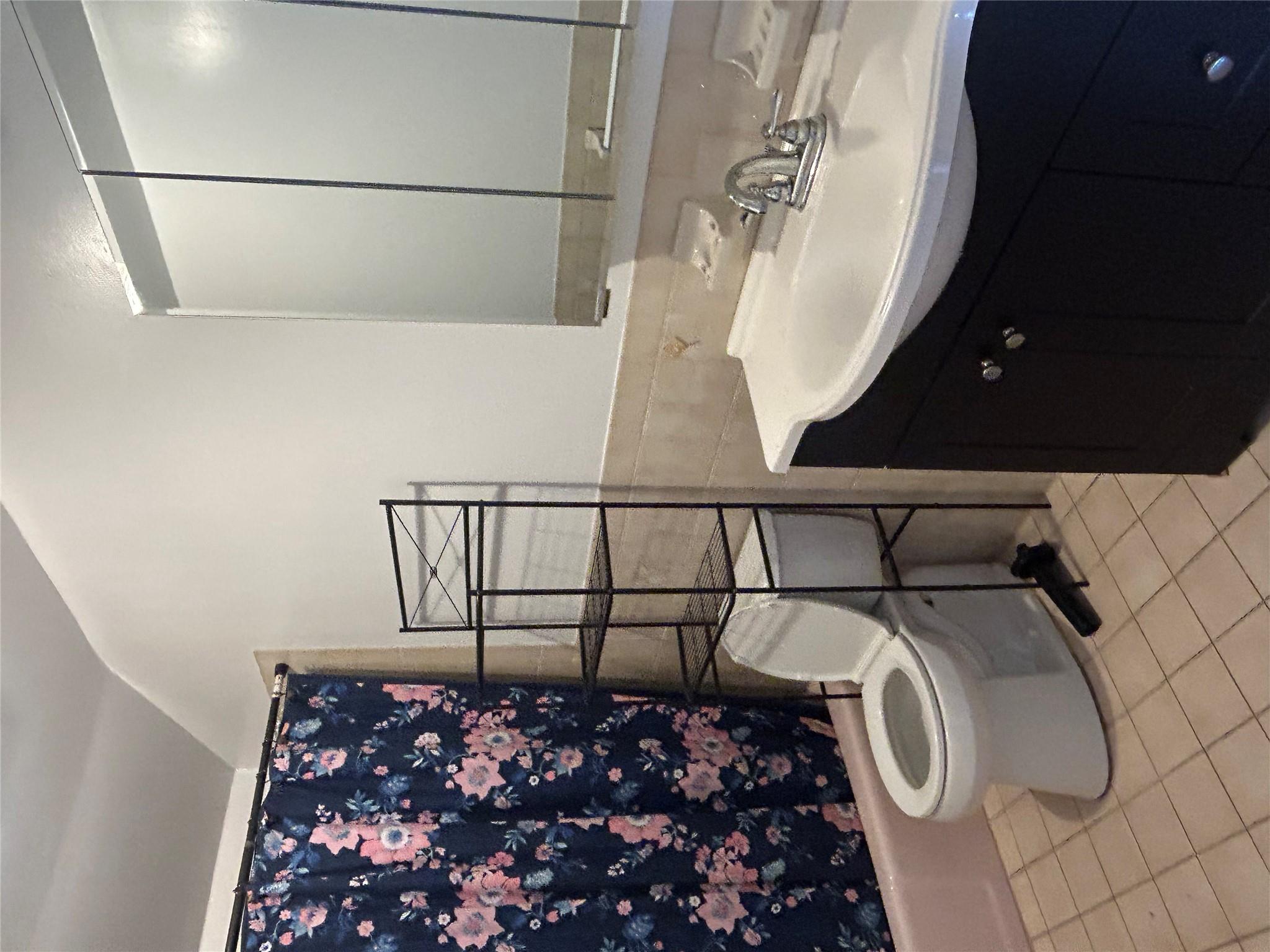 206-18 45th Road, Unit SECOND Queens, NY 11361 - Photo 8 of 14 Full bathroom with vanity, toilet, tile patterned flooring, tile walls, and wainscoting