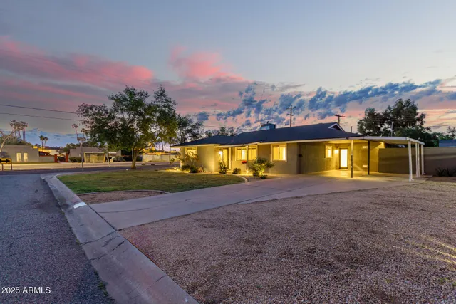 an aerial view of a house with a yard and lake view