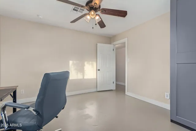 a view of room with workspace and windows