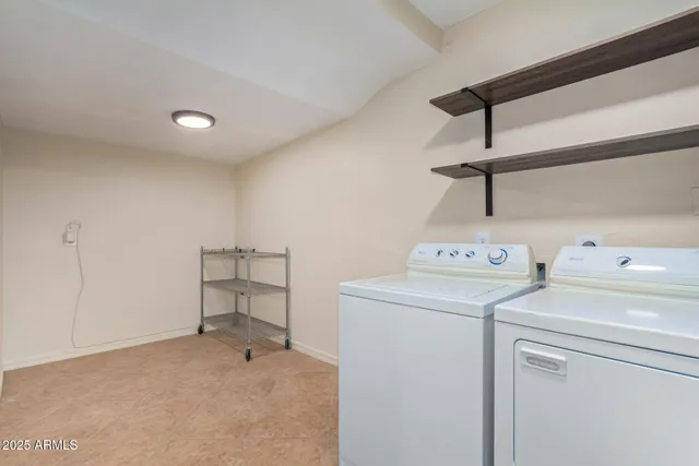 a view of storage and utility room with washer and dryer