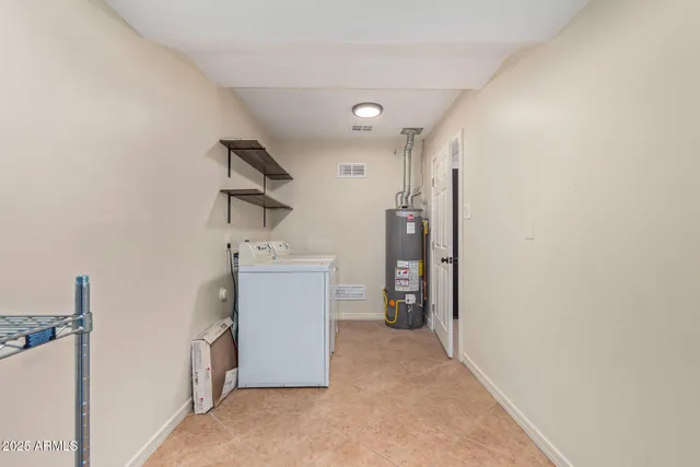 a view of a hallway to a room with windows