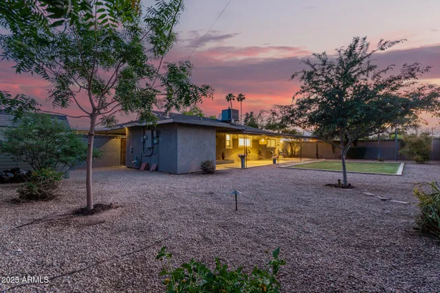 a view of a backyard with swimming pool