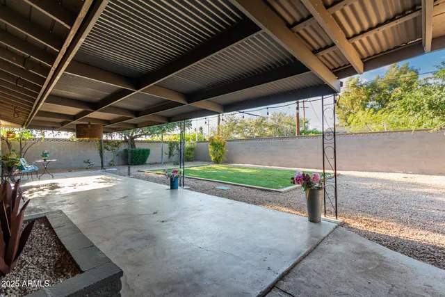a view of a house with backyard and sitting area