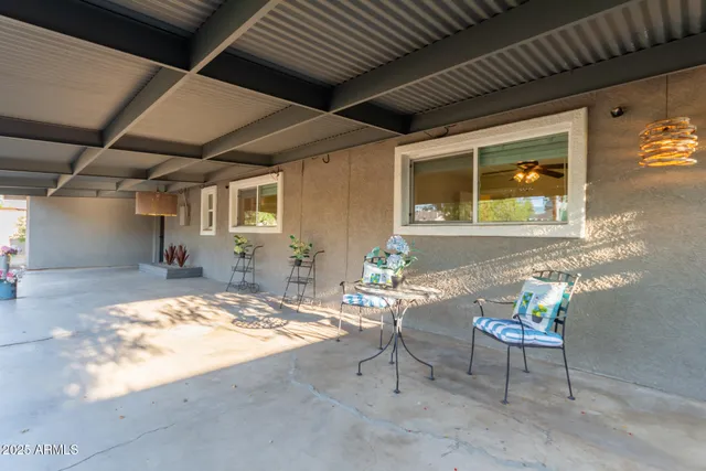 a backyard of a house with plants and tree