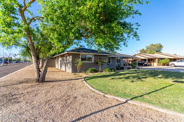 a view of house with outdoor space and swimming pool
