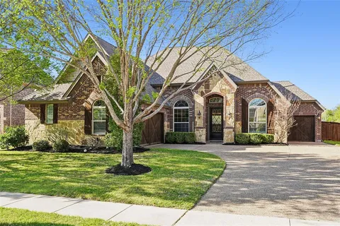 a front view of a building with a garden