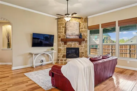 a living room with furniture a flat screen tv and a fireplace