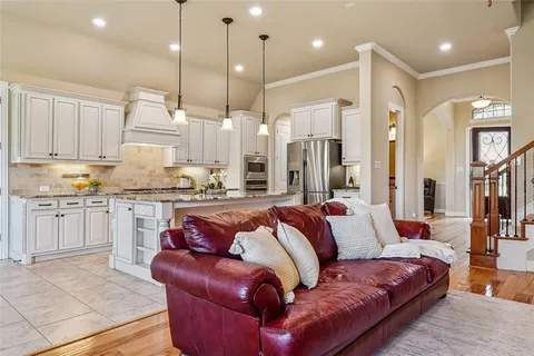 a living room with furniture and kitchen view