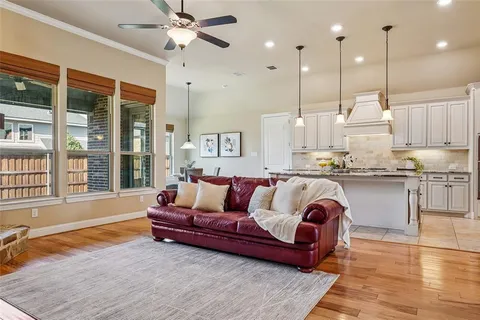 a spacious bedroom with a large bed and a chandelier
