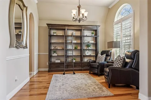 a living room with furniture a rug and a chandelier