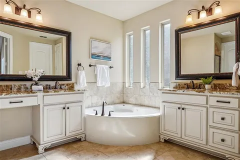 a bathroom with a tub sink and mirror