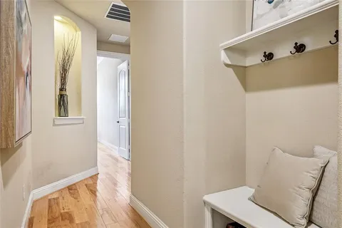 a view of a hallway with furniture and wooden floor