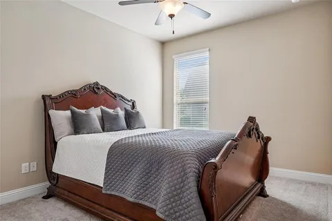 a bed room with a bed and a chair