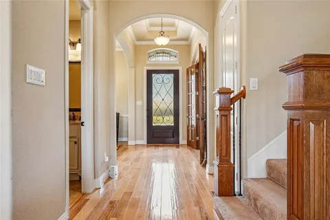 a view of a hallway with wooden floor