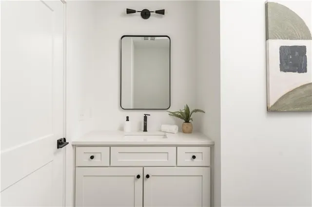 a bathroom with a sink vanity and a mirror