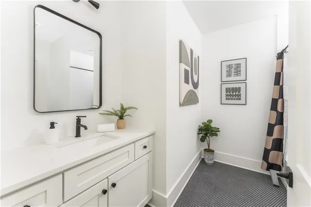 a bathroom with a tub sink and mirror