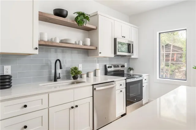 a kitchen with appliances cabinets and a window