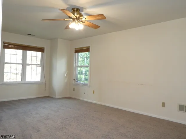 a bathroom with a glass shower door and a window