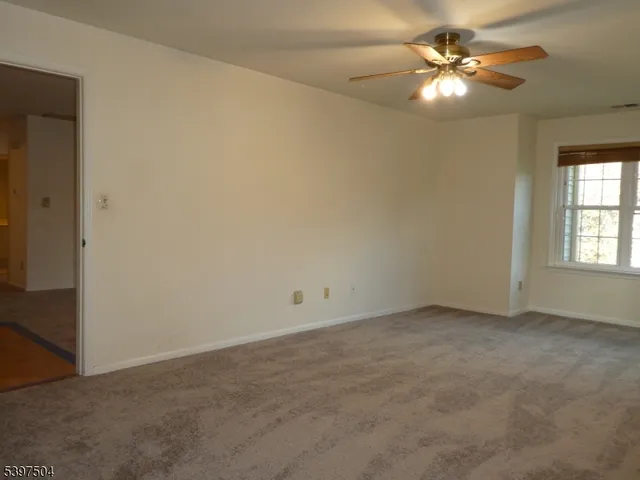a bathroom with a granite countertop sink and large window