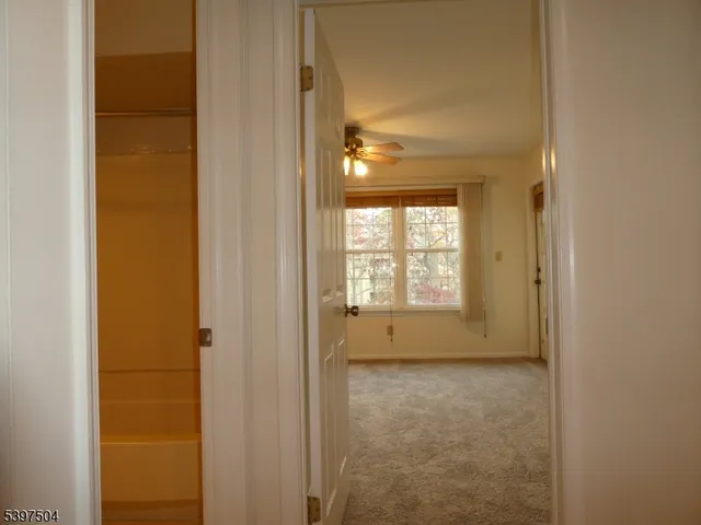 a view of room with window and ceiling fan