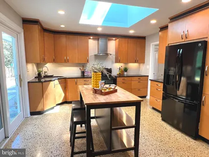 a bathroom with a granite countertop sink mirror and shower