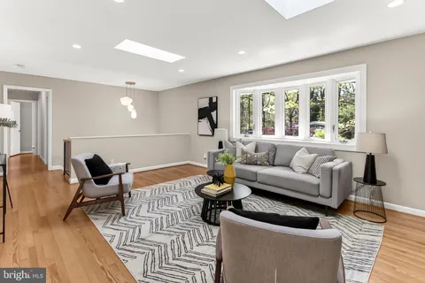 a living room with stainless steel appliances kitchen island granite countertop furniture and a kitchen view