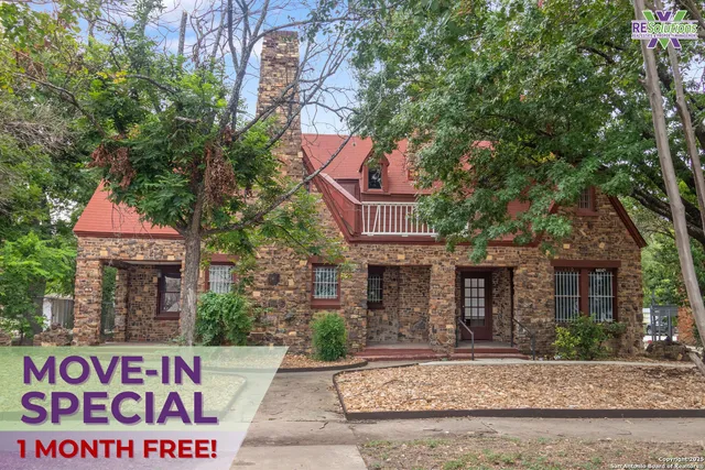 front view of a house with a tree