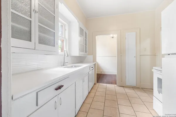 a kitchen with a sink and a refrigerator