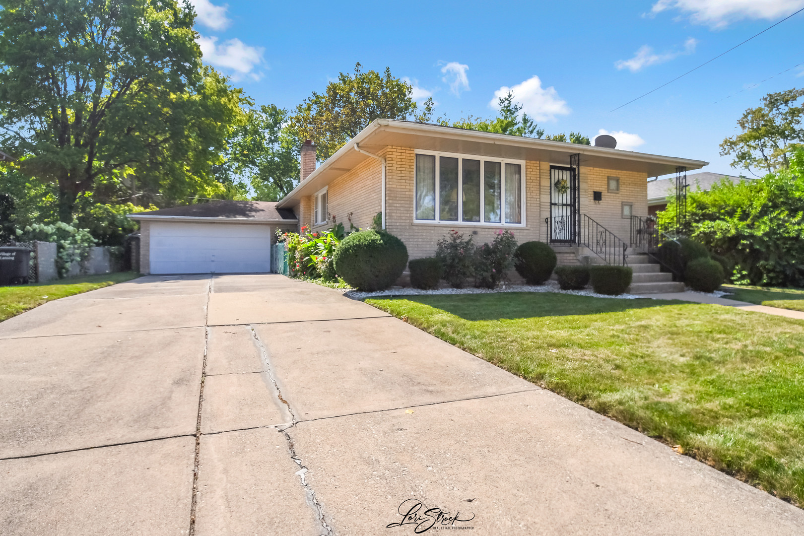 3409 173rd Place Lansing, IL 60438 - Photo 2 of 26 a front view of a house with garden