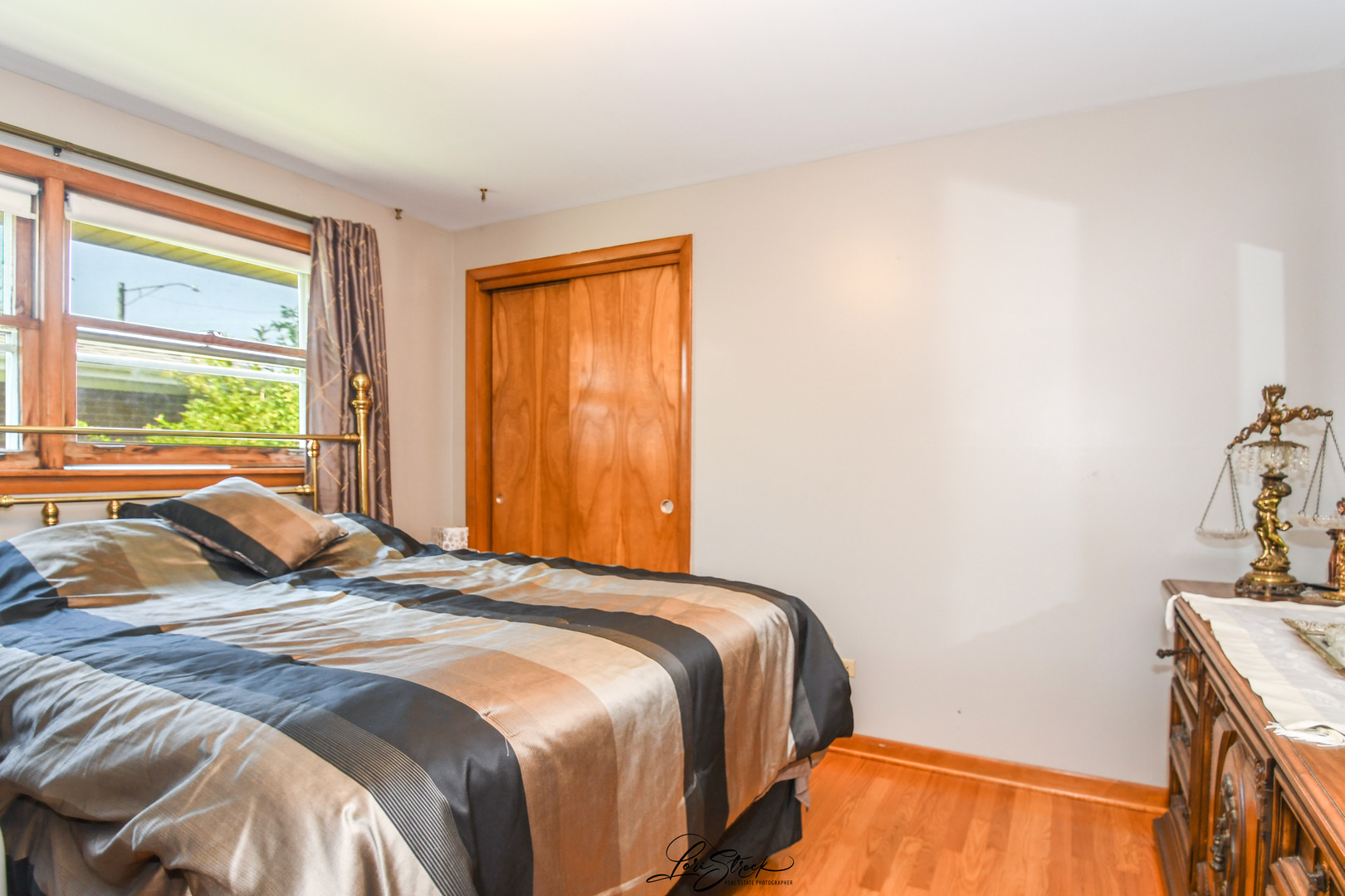 3409 173rd Place Lansing, IL 60438 - Photo 9 of 26 a bedroom with a bed and a window