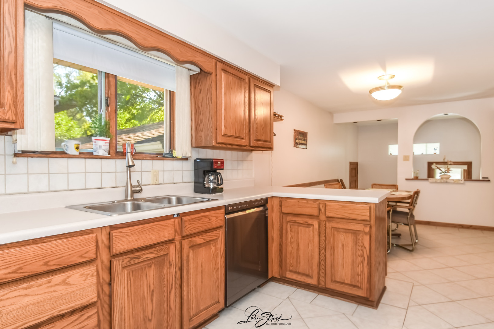 3409 173rd Place Lansing, IL 60438 - Photo 10 of 26 a kitchen with a sink cabinets and window