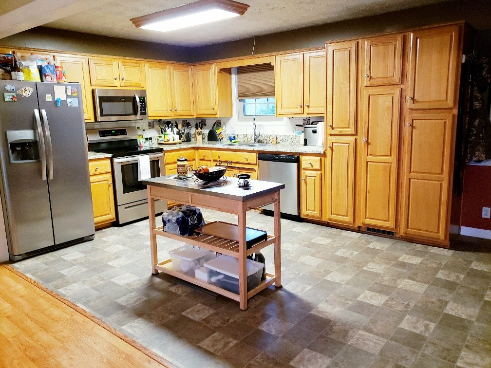 2154 Union Camp Road Lafayette, TN 37083 - Photo 12 of 23 a kitchen with stainless steel appliances granite countertop a refrigerator a stove top oven a sink and cabinets