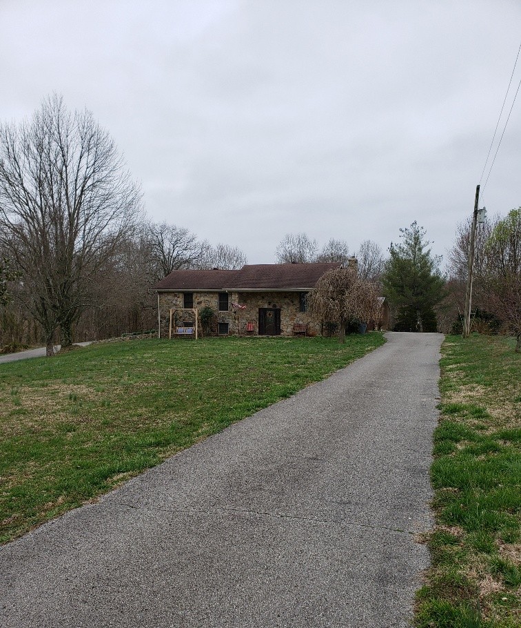 2154 Union Camp Road Lafayette, TN 37083 - Photo 23 of 23 a view of a house with a big yard potted plants and large tree
