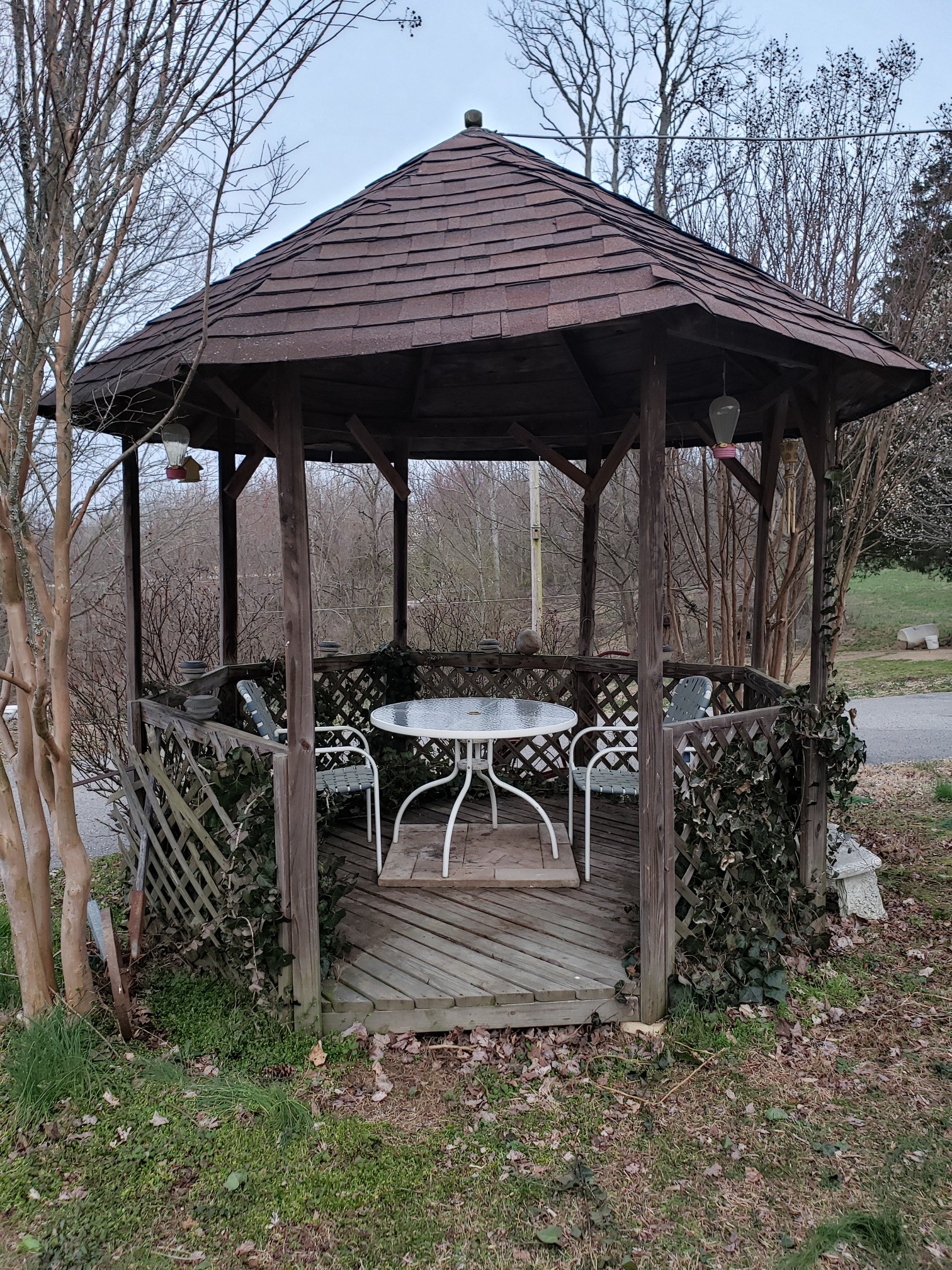 2154 Union Camp Road Lafayette, TN 37083 - Photo 4 of 23 a view of a patio with table and chairs under an umbrella under an umbrella