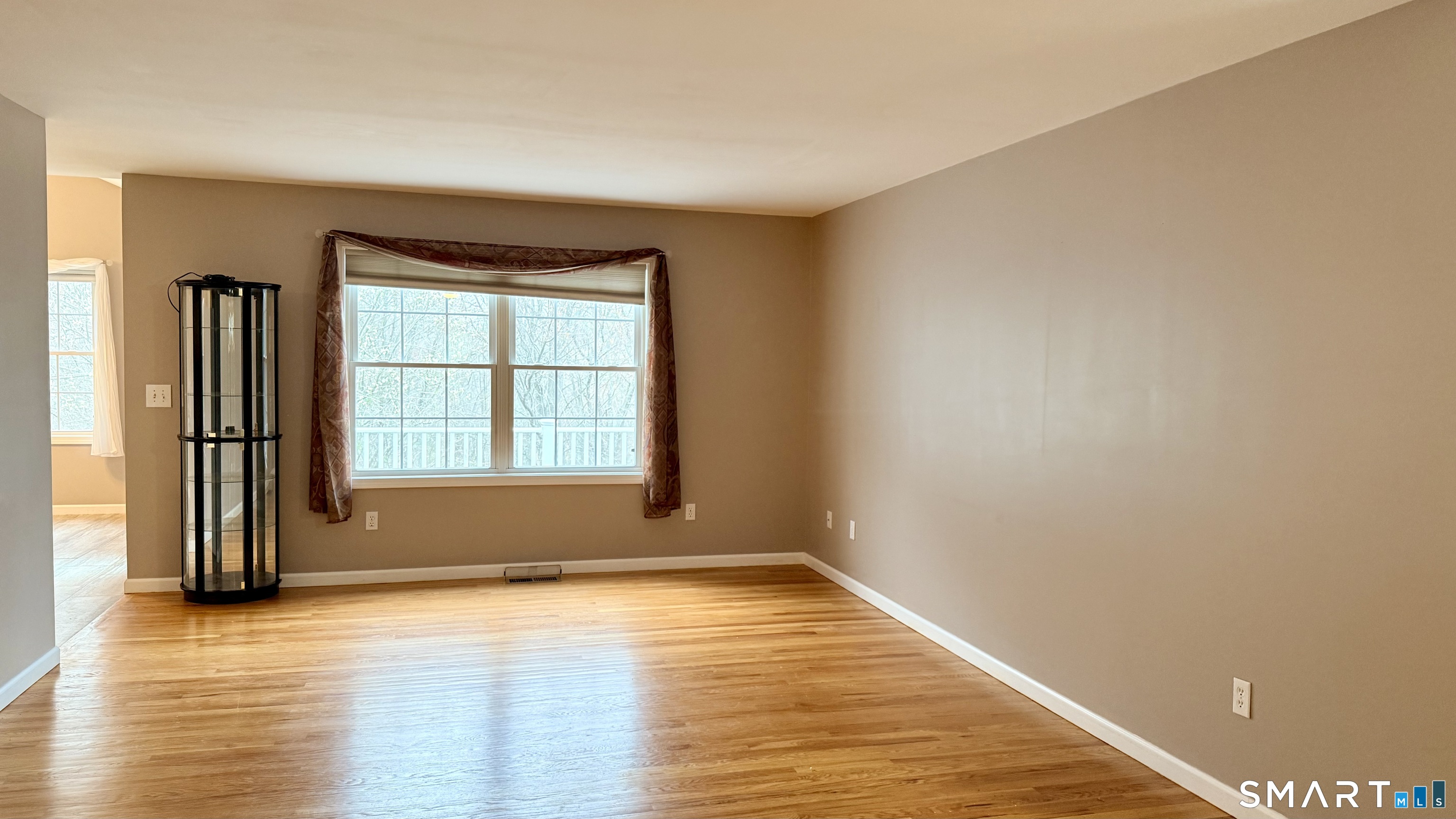 55 Nina's Way, Unit 55 Manchester, CT 06040 - Photo 3 of 25 a view of an empty room with wooden floor and a window
