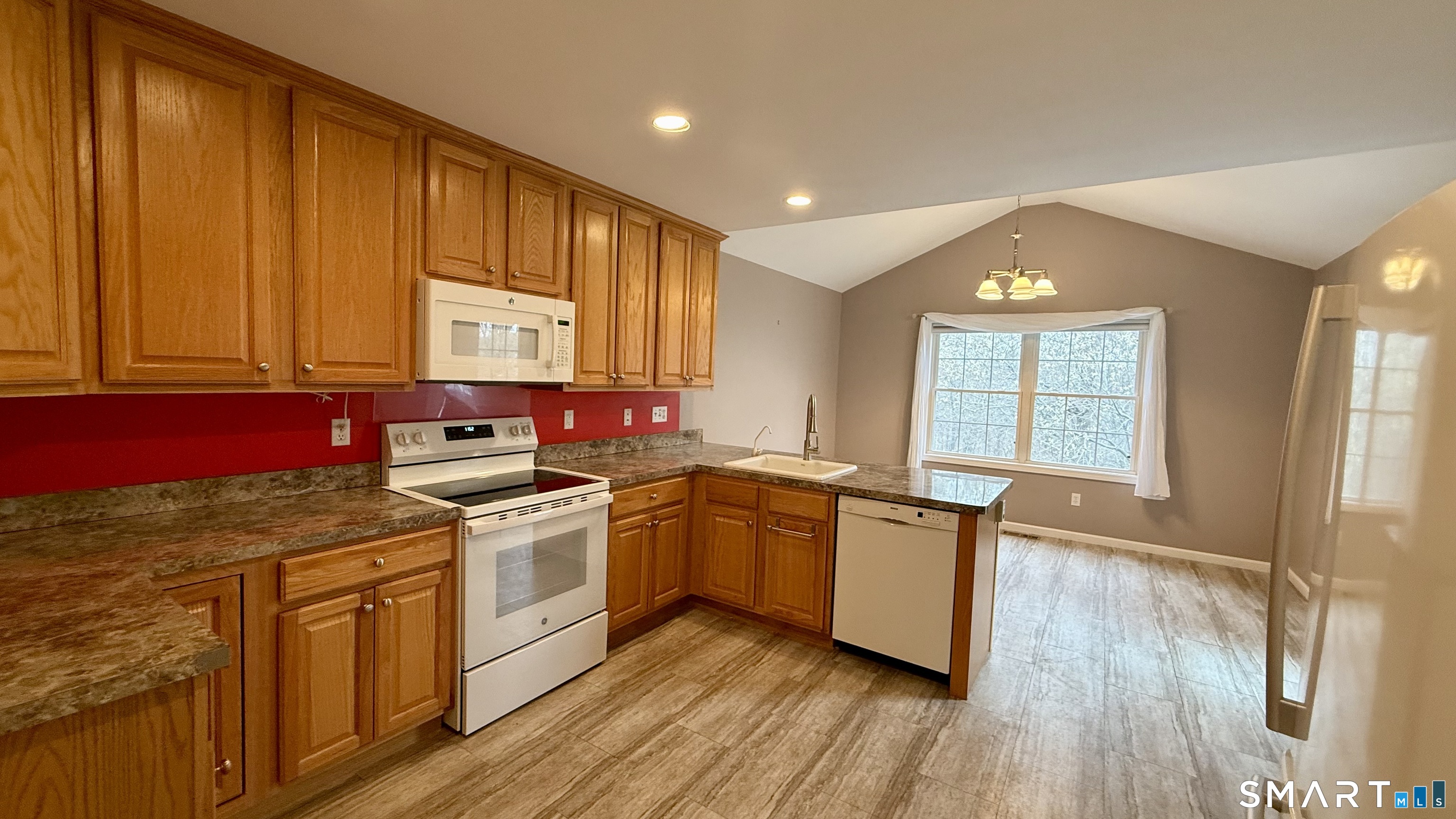 55 Nina's Way, Unit 55 Manchester, CT 06040 - Photo 6 of 25 a kitchen with stainless steel appliances granite countertop a stove a sink dishwasher and a refrigerator with wooden floor