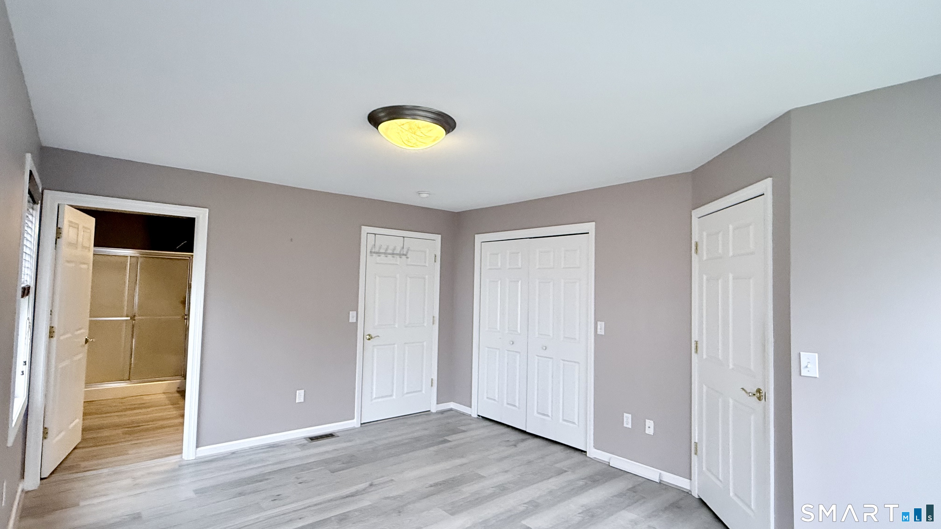 55 Nina's Way, Unit 55 Manchester, CT 06040 - Photo 9 of 25 an empty room with wooden floor and windows