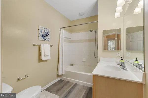 a bathroom with a sink mirror vanity and toilet