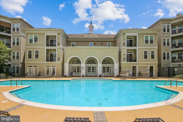 a view of a swimming pool and lounge chair
