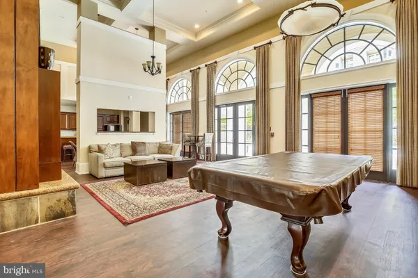 a living room with furniture a fireplace and large windows