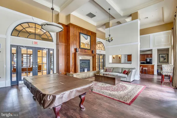 a living room with furniture a flat screen tv and a table