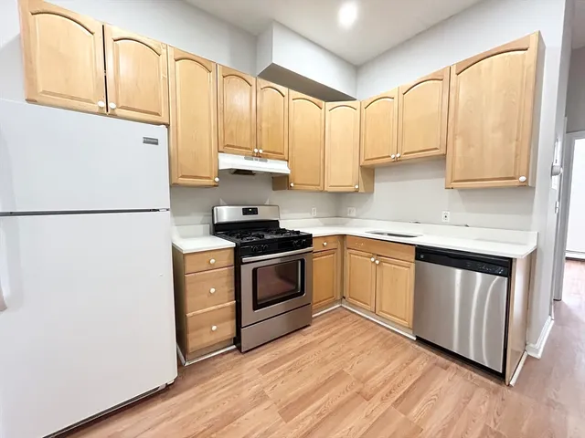a kitchen with stainless steel appliances a refrigerator sink and cabinets