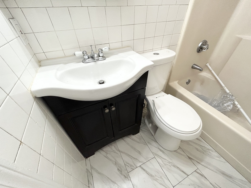 96 Hammond Street, Unit 1 Boston, MA 02120 - Photo 13 of 14 a bathroom with a sink toilet and shower