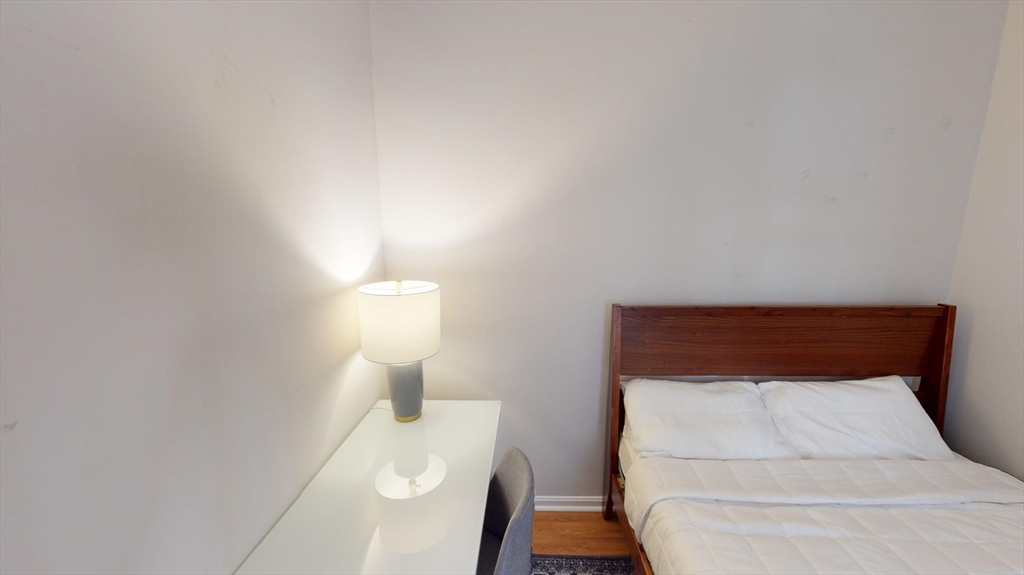 96 Hammond Street, Unit 1 Boston, MA 02120 - Photo 8 of 14 a bedroom with a bed and a night stand