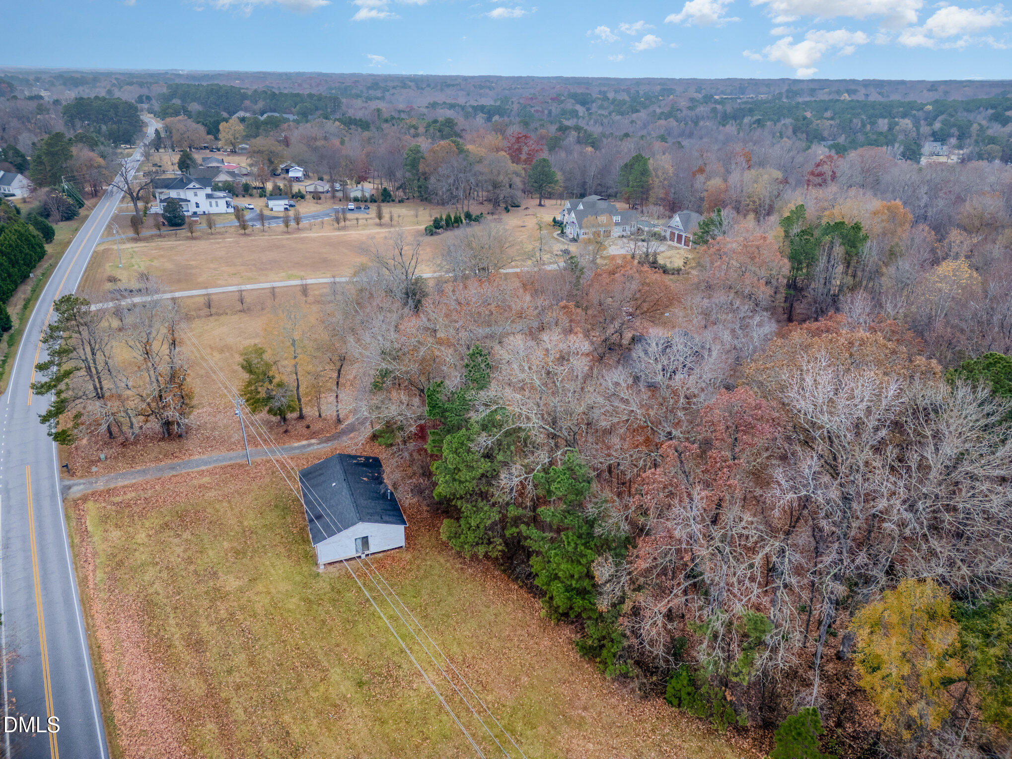 6801 Rock Service Station Road Raleigh, NC 27603 - Photo 28 of 36 an aerial view of a house with a yard and lake view
