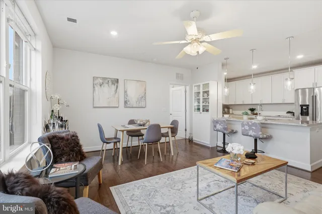 a bedroom with a bed painting and a window